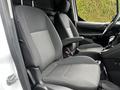 Interior of a 2016 Ford Transit Connect showing two front seats with gray fabric and armrests