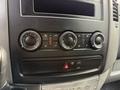 Control panel of a 2012 Mercedes-Benz Sprinter featuring climate control knobs and buttons for air conditioning and hazard lights