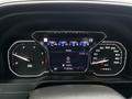 The dashboard of a 2022 GMC Sierra 3500HD displaying digital speedometer and odometer readings along with navigation information and other gauges