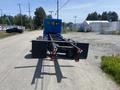 A blue 2008 Peterbilt 340 truck cab with a flatbed chassis viewed from the rear showing the truck's taillights and frame