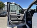 A 2020 Ford F-350 SD with an open front door showcasing the interior details and controls