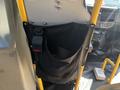 A 2017 Chevrolet Express van featuring a black fabric bag mounted on the interior wall with a seatbelt buckle attached to it
