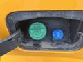 Close-up of a fuel compartment on a 2017 Ford F-250 SD featuring a green diesel cap and a blue cap