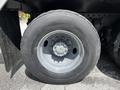 Close-up view of a gray tire mounted on a silver wheel of a 2010 Freightliner M2 106 truck