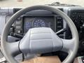 Close-up of the steering wheel and dashboard of a 2008 Mitsubishi Fuso FE180 displaying gauges and control buttons