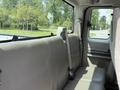 Interior of a 2008 Ford F-250 SD showing a rear bench seat with beige upholstery and a seatbelt attached