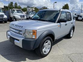 A silver 2006 Land Rover LR3 with a boxy shape and a bold front grille showing off its distinctive branding and round headlights