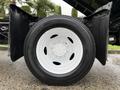 A close-up view of a white wheel on a 2022 Ford F-550 truck showcasing the tire tread and wheel design