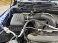 Close-up view of the engine compartment of a 2019 RAM 1500 Classic showing the air intake and various components including hoses and the air filter box