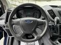 Steering wheel of a 2017 Ford Transit 350 with a Ford logo and dashboard display visible