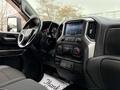 Interior view of a 2021 Chevrolet Silverado 3500HD featuring a dashboard with a touchscreen display and climate control knobs