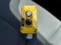 A yellow control panel with two buttons labeled up and down on a textured surface