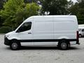 A 2020 Mercedes-Benz Sprinter van in white with a black stripe on the lower section and alloy wheels
