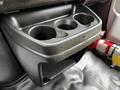 Cup holder assembly with three open slots and a lower compartment in a 2019 Chevrolet Express