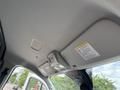 Interior view of a 2023 Ford Transit showing the ceiling with lights and warning labels
