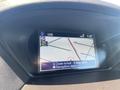 Dashboard display of a 2017 Acura TLX showing a map with GPS coordinates and navigation options