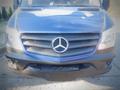 A blue 2017 Mercedes-Benz Sprinter with a prominent three-pointed star logo on its grille and a sleek front design