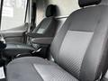 Front seats of a 2020 Ford Transit featuring gray fabric upholstery and adjustable armrests