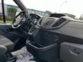 Interior view of a 2018 Ford Transit focusing on the driver's seat dashboard gear shifter and control panel