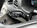 Close-up of the control stalk on a 2023 Ford Transit with icons for indicators and windshield wipers
