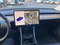 Interior view of a 2019 Tesla Model 3 displaying a touchscreen interface with a map and a blue car icon