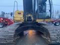 2014 John Deere 350G excavator with a yellow and black exterior and large tracks visible in the foreground