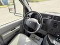 Interior view of a 2010 Ford Econoline showing the steering wheel and dashboard with various controls and gauges