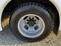 A close-up of a tire mounted on a 2017 Chevrolet Express featuring rugged tread and a silver rim with multiple lug nut openings