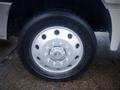 Close-up of a silver wheel with multiple holes and a prominent central hub on a 2015 International TerraStar truck