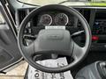 The interior view of a 2018 Isuzu NRR showing the steering wheel dashboard gauges and control panel