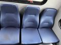 Three blue vinyl seats designed for a Chevrolet Express van