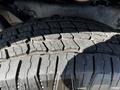 Close-up of a tire from a 2023 Toyota Tundra showing tread patterns and surface detail