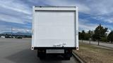 A 2018 Mitsubishi Fuso FE truck with a plain white box cargo area and tailgate visible from the rear