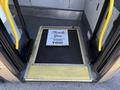 A 2016 Grande West Vicinity bus showing an open doorway with a welcome mat that reads Thank You IT'S BEEN A PLEASURE SERVING YOU