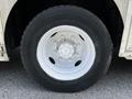 Close-up of a white wheel with multiple spokes mounted on a black tire of a 2008 Morgan Olson Workhorse