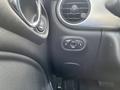 Interior view of a 2005 Chrysler PT Cruiser showing climate control vents and a power window switch on the driver's side door panel