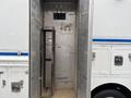 Interior of a 2012 Workhorse W62 cargo area showing metal shelving and a vertical compartment with bare walls and a small opening above
