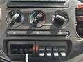 The image shows the dashboard controls of a 2009 Ford F-550 featuring climate control knobs and auxiliary switches