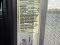 A 2016 Peterbilt 348 vehicle identification label displaying specifications including weight limits tire information and compliance standards