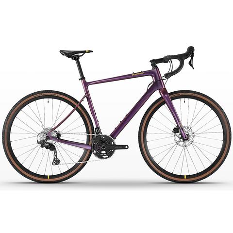 A 2026 Boardman ADV 9.0 Carbon Gravel Adventure Road Bike featuring a sleek purple frame with disc brakes and wide tires designed for versatile terrain handling