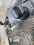 Close-up of the control joystick of a 2012 John Deere 310SJ heavy machinery with a textured grip and nearby foot pedals visible