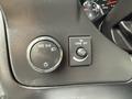 Close-up of a 2013 Chevrolet Express dashboard featuring a headlight control knob and a dome light switch