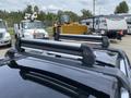 A 2015 Kia Sorento with a roof rack featuring crossbars attached to the top of the vehicle