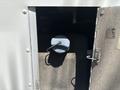 A blue cap on a container inside a compartment of a 2019 Freightliner MT45 vehicle