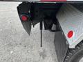 The image shows the rear section of a 2013 Kenworth T370 including the trailer hitch and mud flaps on a truck with a metallic finish and red lights