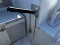 A 2004 Freightliner M2 with a metal lever and two chains attached to a panel showing industrial design elements and textured surfaces