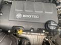 Close-up view of the engine cover of a 2018 Buick Encore featuring the ECOTEC logo and oil cap with the dexos1 label and dipstick with yellow handle