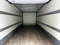 Interior of a 2020 Hino 338 truck showing an empty cargo area with wooden flooring and metal strip reinforcements along the walls