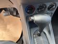 Interior view of a 2010 Ford Transit Connect showing the gear shift lever and climate control knobs on the center console