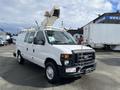A white 2008 Ford Econoline van with a bucket lift attached on top and equipped with utility tools for maintenance or construction work
